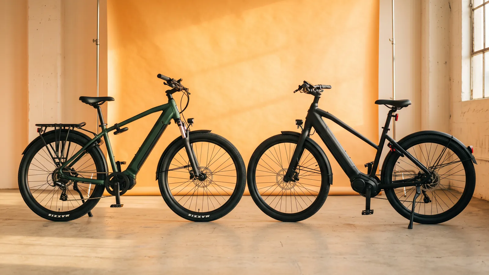 Two e-bikes side by side in a warm studio