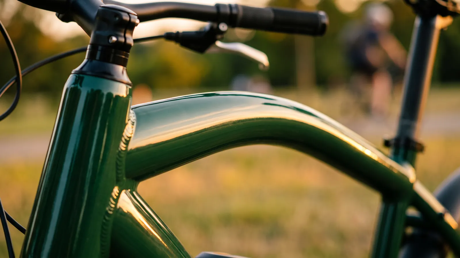 Curved green top tube of an e-bike frame